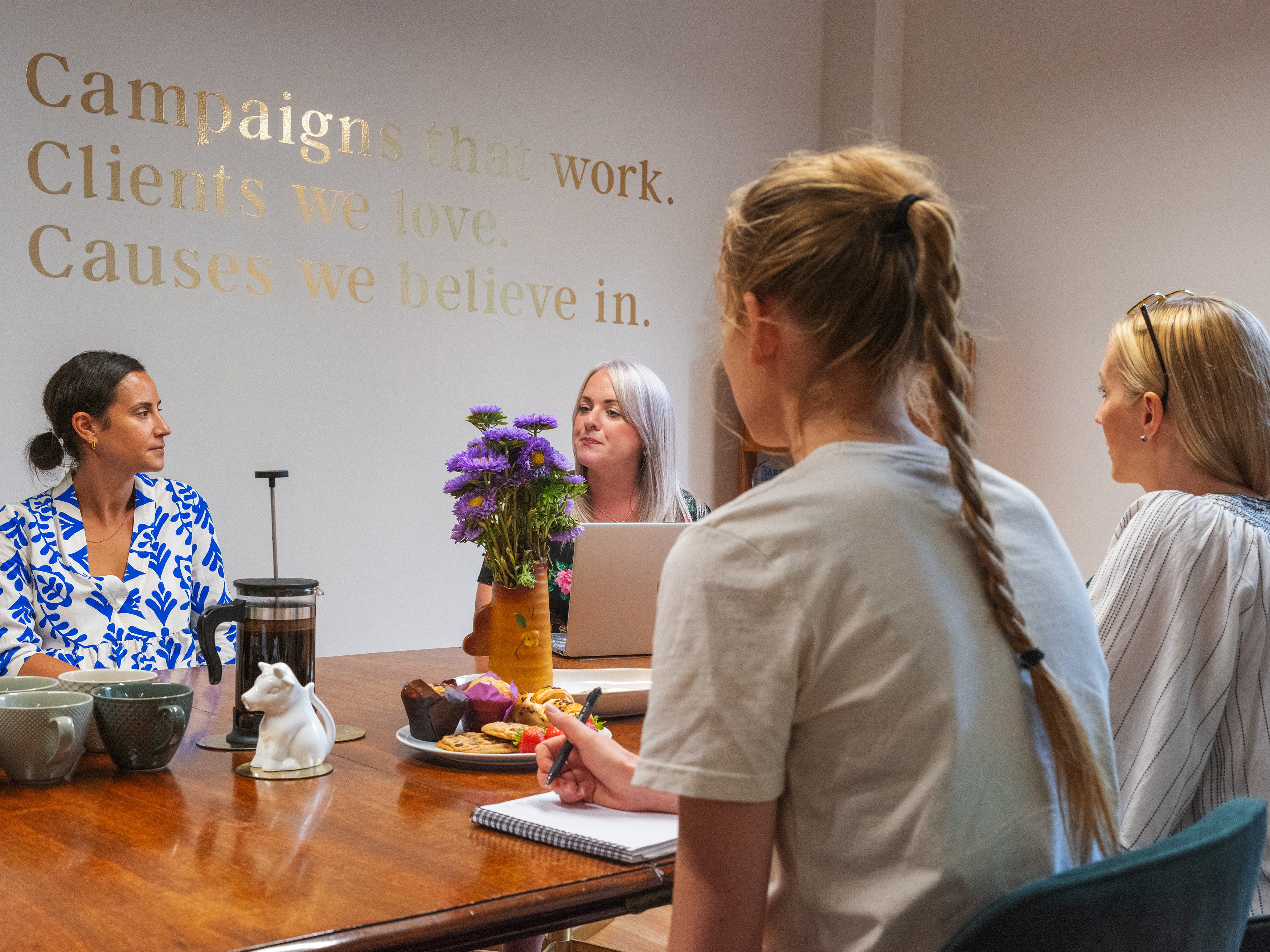 Several smartly dressed people in a meeting room