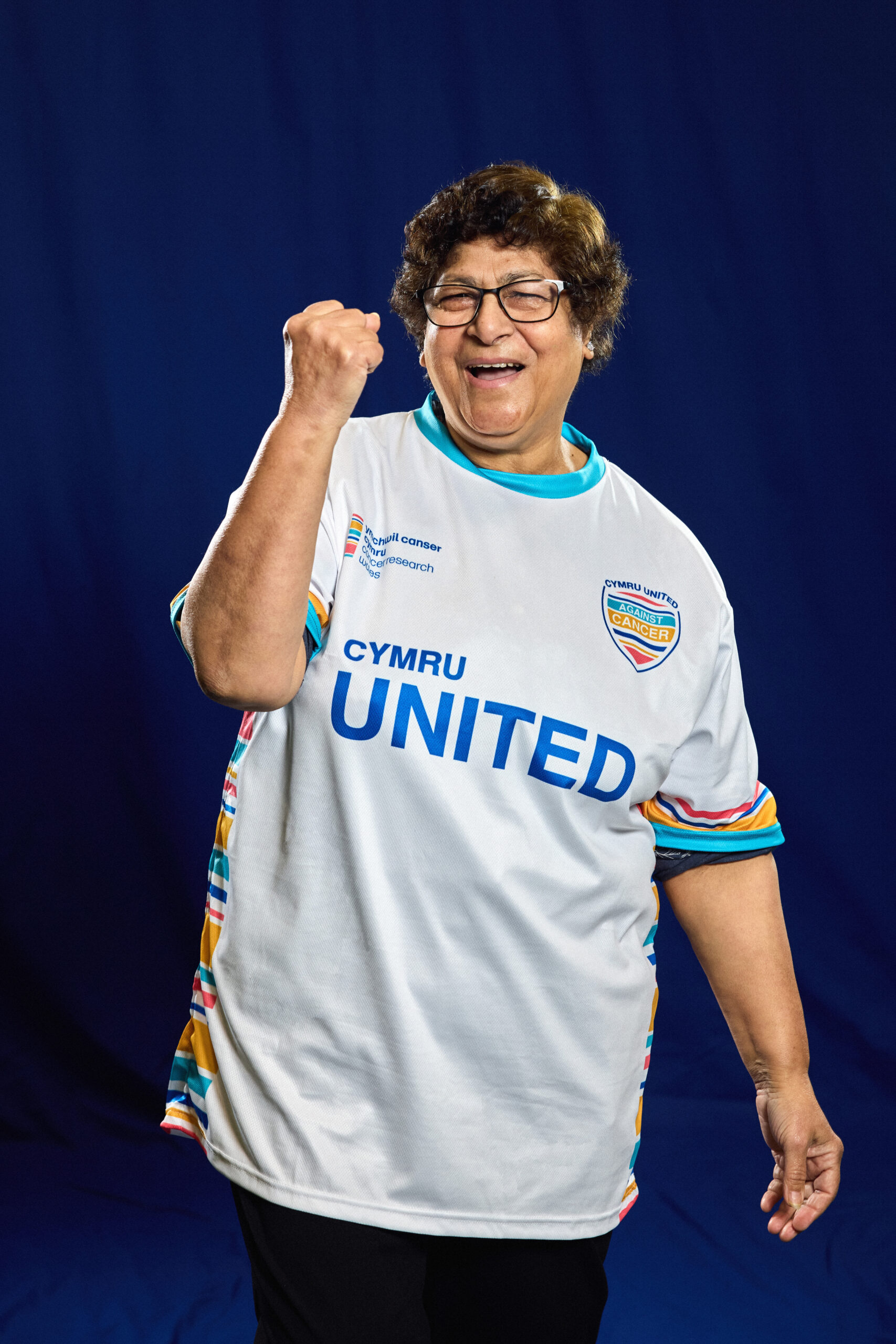 Woman punching arm into the air, celebrating.